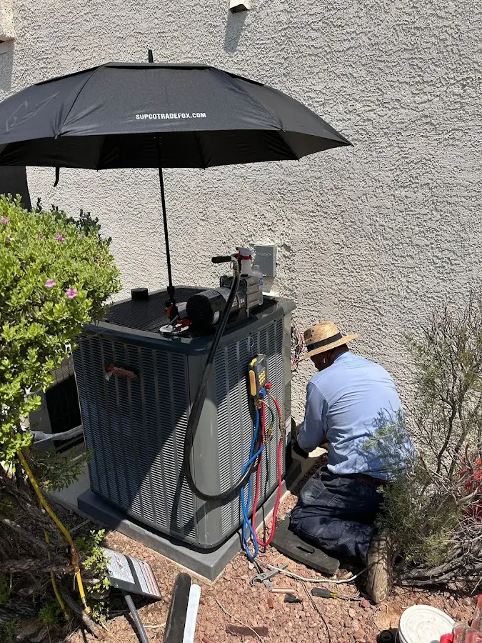HVAC technician performing outdoor AC maintenance in Aurora